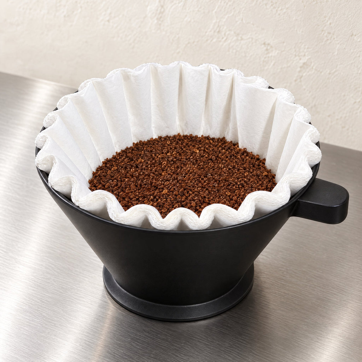 BUNN regular paper filter with ground coffee in a commercial brew funnel